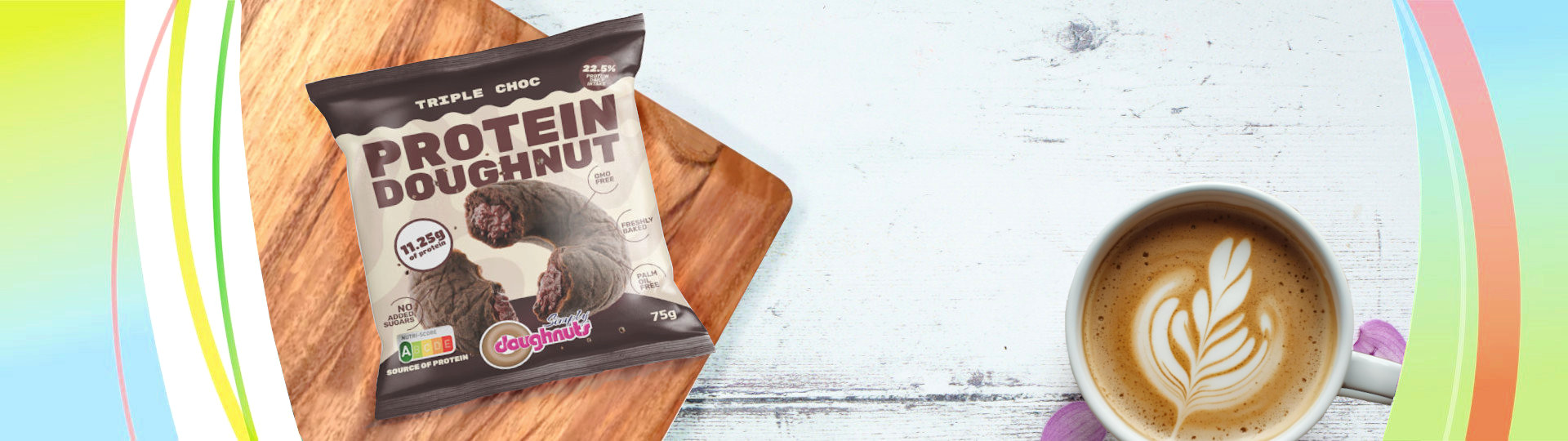 Protein Doughnut in its packaging on a wooden board beside a cup of coffee
