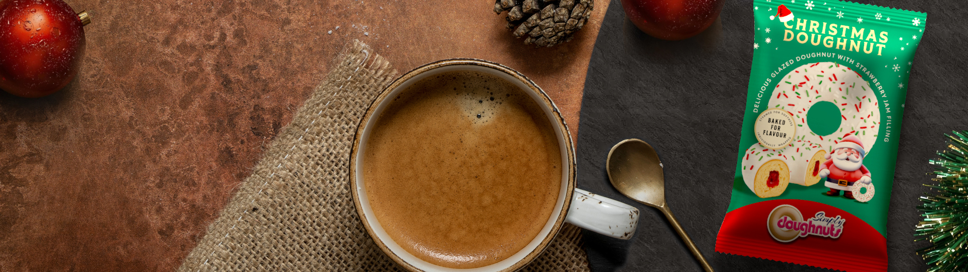 Christmas themed ring doughnut, with tinsel and baubles: season's greetings from Simply Doughnuts